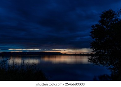 kochelsee, lake, night, nightsky, mirror, dark, clouds, rain, dramatic, sunset, afterglow, hills, tree, reed, lakeside, reflection, mood, wallpaper, orange, blue - Powered by Shutterstock