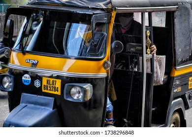 Kochi, India - May 2020: A Tuk Tuk Driver Wearing A Face Mask Carrying A Passenger During Confinement Due To The Covid-19 Pandemic On May 22, 2020 In Kochi, Kerala, India.