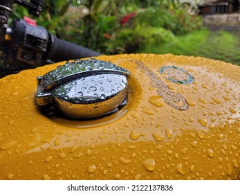 Kochi, Kerala - 8 October 2021 - A rain covered tank of a yellow Royal Enfield Continental GT motorcycle. 
