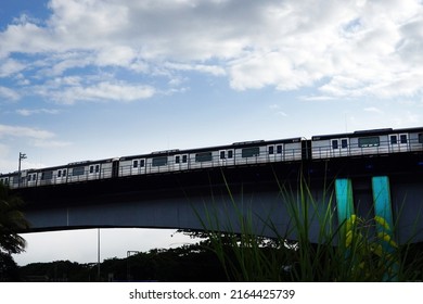 Kochi, Kerala, India, June 03, 2022: Train Passing Through An Overhead Metro Train Track.                            