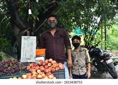 Kochi  , Kerala  / INDIA - September 12, 2020: A Father And Son Wearing Mask Due To Corona Pandemic And Selling Fruits In Street Market Of Kerala. 