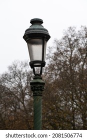 Koekelberg, Brussels Capital Region, Belgium - 11 19 2021: Vinate Streetlight And A Backgroudn Of Colorful Foliage