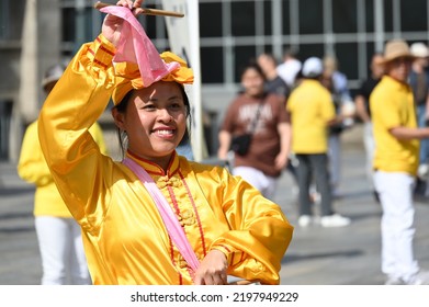 Koeln, Germany - June 25, 2022: Representatives Of Falun Gong, Also Known As Falun Dafa, A New Spiritual Practice And Movement, Demonstrate In Front Of The Cathedral Against Their Oppression In China