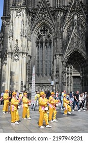 Koeln, Germany - June 25, 2022: Representatives Of Falun Gong, Also Known As Falun Dafa, A New Spiritual Practice And Movement, Demonstrate In Front Of The Cathedral Against Their Oppression In China