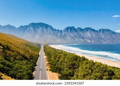 Kogelbay Beach Western Cape South Africa, Kogelbay Rugged Coast Line with spectacular mountain road. Garden Route. couple of men and women walking on the road, drone aerial view - Powered by Shutterstock