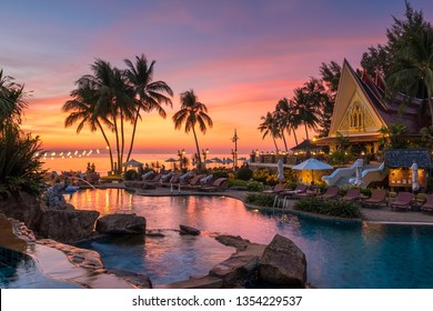 Koh Chang, Thailand - December 18, 2018: Beautiful Sunset View With Palm Trees Reflecting In Swimming Pool In Luxury Island Resort In Thailand