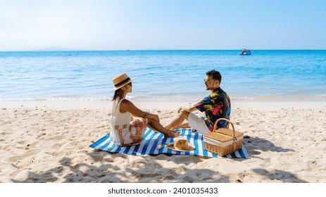 Koh Larn Island near Pattaya Thailand, the tropical beach of Koh Larn Thailand, a white beach with clear water ocean. Tropical Island. a couple of men relaxing on the beach with a picnic - Powered by Shutterstock