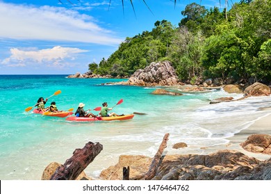 Koh Lipe,Thailand - Jul. 17 2019 - Multiracial Family In Kayak Arriving At A Wild And Tropical Paradise Beach