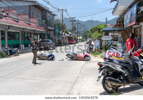KOH\
PHANGAN, THAILAND - MAY 19, 2019 : Motorcycle accident that\
happened on the road at tropical island Koh Phangan, Thailand .\
Traffic accident between a motorcycle on\
street