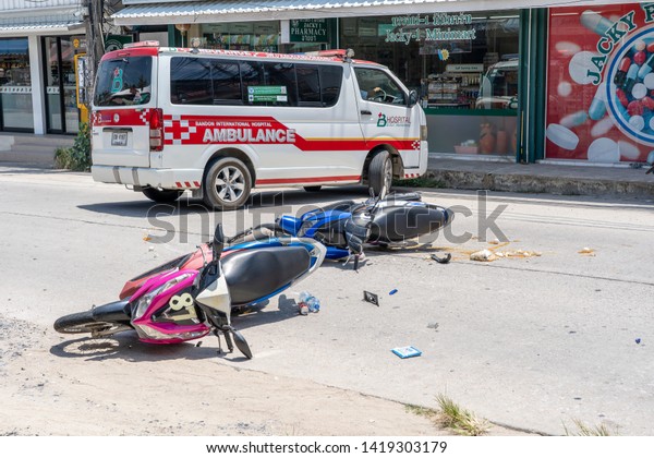 KOH\
PHANGAN, THAILAND - MAY 19, 2019 : Motorcycle accident that\
happened on the road at tropical island Koh Phangan, Thailand .\
Traffic accident between a motorcycle on\
street
