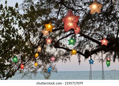 Koh Samed Island, Thailand - 20 April 2022: Tree Decorated With Colorful Star Lanterns And Romantic Fairy Lights At Restaurant Sunset Dinner On The Beach