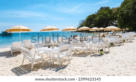 Koh Samet Island Rayong Thailand, beach chairs sunbed with umbrellas at the white tropical beach of Samed Island with a turqouse colored ocean and a blue sky
