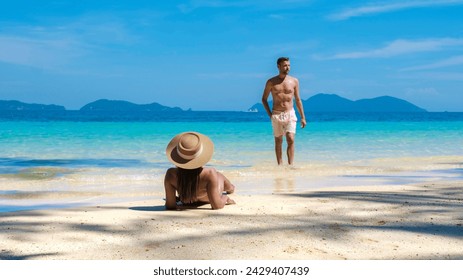 Koh Wai Island Trat Thailand is a tinny tropical Island near Koh Chang. a young couple of men and women on a tropical beach lying down sunbathing during a luxury vacation in Thailand - Powered by Shutterstock