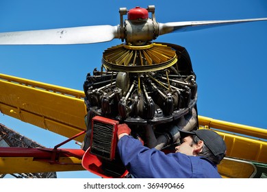 Koktebel, UKRAINE - JANUARY 05, 2014: Mechanic Repairs Airplane Engine. Airplane Maintenance. Aviation Engineer. Aircraft Technician At Work 05, 2014 In Koktebel