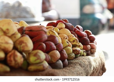 The kola nut is a caffeine-containing nut of evergreen trees of the genus Cola, primarily of the species Cola acuminata and Cola nitida. Nima market where kola nut is sold. - Shutterstock ID 1993712516