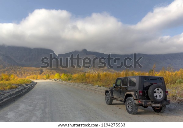 Kola peninsula. Murmansk\
region, Russia, September 10, 2018: black Jeep Wrangler Sahara on a\
mountain pass in the Murmansk region. Off road and sport utility\
vehicle