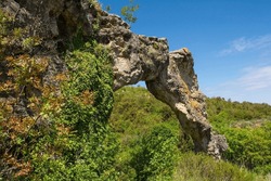 Kolac Rock Arch Near Nerezisca On Brac Island, Croatia. A Result Of A Mixture Of Steambank, Wind, Water And Temperature Erosion, And Protected As A Geomorphological Monument Of Nature
