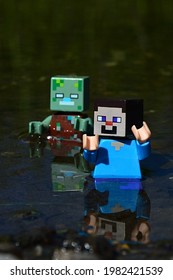 KOLAROVO, SK - MAY 28, 2021: Minecraft LEGO Figure Of Steve Chased By Drowned Zombie Hostile Mob Figure In Shallow Waters, Daylight Sunshine.