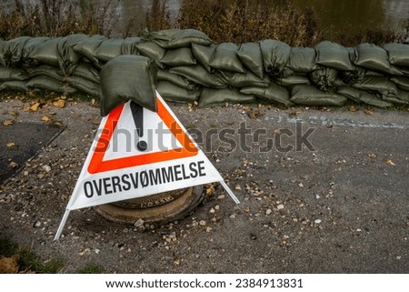Kolding, Denmark A temporary flood warning triangle sign in Danish says Attention ! Flooding.