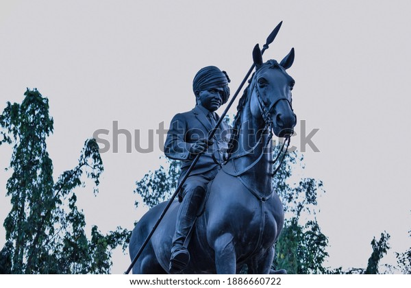 Kolhapur , Maharashtra , India- May 15th 2019; Photo mural of a Statue of great Indian warrior on horseback carved using black granite stone.