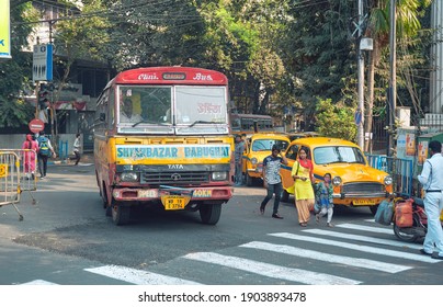 Kolkata, 01-09-2021: Movement Of Traffic In City Street. A Vintage Looking Minibus And Yellow Ambassador Taxis Are Seen On Road, As People Are Waiting At Bus-stop.