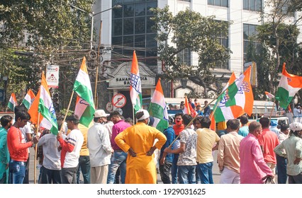 Kolkata, 02-28-2021: Gathering of Indian Congress party workers walking in a political rally on their way to attend Brigade Parade Ground meeting. Some of them are carrying tri-colour party flags.