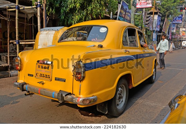 KOLKATA (CALCUTTA), WEST BENGAL, INDIA - OCTOBER 02,\
2014: Back of an  isolated Yellow taxi. Ambassador, modeled after\
the British Morris Oxford, was the first car to be made in this\
country. 