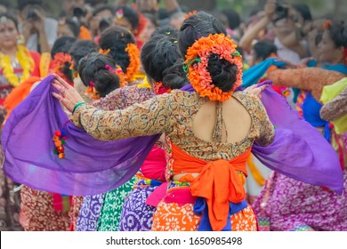 Kolkata, India- 1st March 2018: Girl dancers,dressed in colourful sari (traditional Indian dress) and Palash flowers (Butea monosperma) make up,dancing at Dol (in Bengali) or Holi (in Hindi) festival.