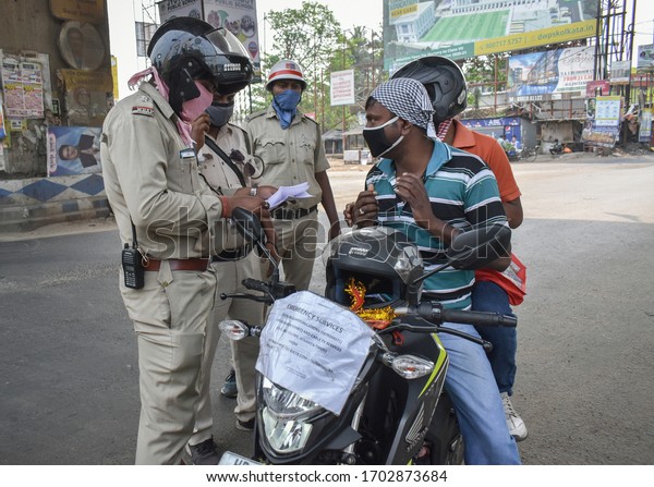 Kolkata,\
India, 5/4/2020 - Police officers checking the documents on Lock\
down period for Covid-19 in Kolkata, India.\
