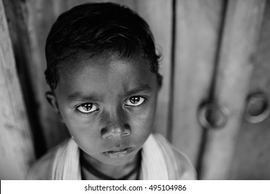 KOLKATA, INDIA   APRIL 15, 2015: Poor Indian Boy Looks In The Camera With Big Sad Eyes