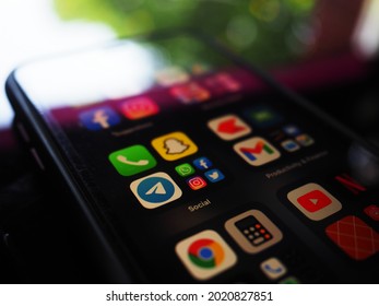 KOLKATA, INDIA - Aug 05, 2021: New iPhone X mobile phone with apps over black background  Whats app,Facebook,snap chat,mapand may more app are there in homepage of iPhone