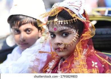 KOLKATA / INDIA - AUGUST 14 2020: Little children in India dresses as bride and groom in fancy dress competition. The girl is wearing Bengali saree and the boy is wearing punjabi