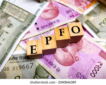 Kolkata, India, dated 12.09.2021. Employees' Provident Fund Organisation or EPFO with wooden bids or blocks on indian rupees notes.