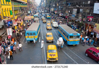 KOLKATA, INDIA - JAN 13: Antique yellow Ambassador taxi cabs down the busy street on January 13, 2013 in West Bengal. First Ambassador was produced by the Yellow Cab Manufacturing Company in 1921