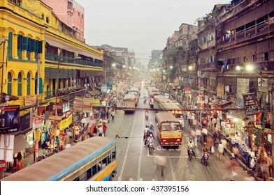 KOLKATA, INDIA - JAN 17: Huge city with traffic scene and colorful buildings in business district with moving buses on January 17, 2016. Kolkata has a density of 814.80 vehicles per km road length