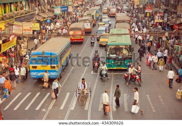 KOLKATA, INDIA - JAN 20: Crossroad of busy modern\
city in Asia with cars, bikes, walking people and buses on January\
20, 2016 in Calcutta. Kolkata has a density of 814.80 vehicles per\
km road length