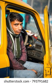 KOLKATA, INDIA - JANUARY 10, 2018: A Driver Sitting In An Indian Yellow Taxi Hindustan Motors Ambassador Model