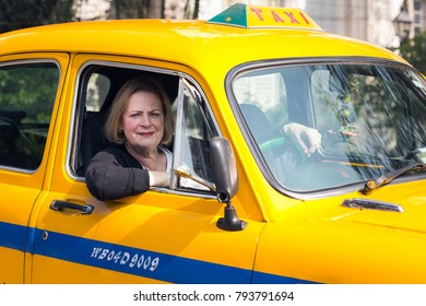 KOLKATA, INDIA - JANUARY 10, 2018: A Tourist Sits In An Indian Yellow Taxi Hindustan Motors Ambassador Model