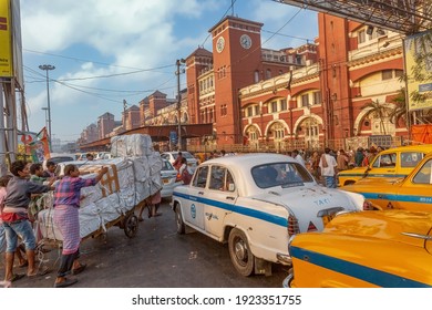Kolkata, India, January 10, 2021: View of busy Howrah station with traffic jam and view of hand drawn cart with railway freight at Kolkata India