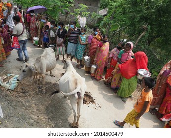 KOLKATA, INDIA - Jun 30, 2021: Sunderbans,India: Flood-affected people gather in que to receive food at relief camp in Sunderban, West bengal 