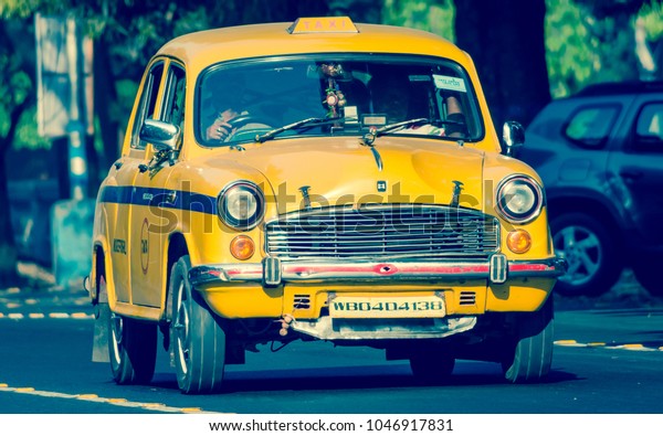Kolkata, India - March 11th 2018: Iconic yellow\
taxi in Calcutta ( Kolkata ) India. The Ambassador taxi is no more\
built by Hindustan Motors but thousands still remain on the streets\
of many India