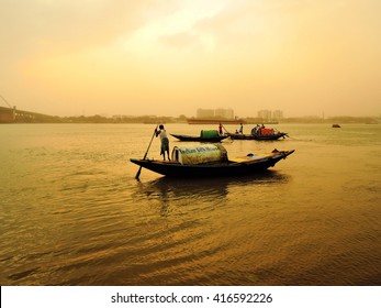 Kolkata, India - May 01, 2016: A Fisherman Rides Across The River Ganges In The Midst Of A Dust Storm During Sunset.