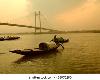 Kolkata, India - May 01, 2016: A Fisherman Rides Across The River Ganges In The Midst Of A Dust Storm During Sunset.