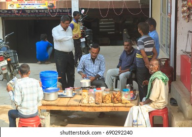 KOLKATA, INDIA - November 25, 2015 : Unknown people drinking a tea at a small market beside the road