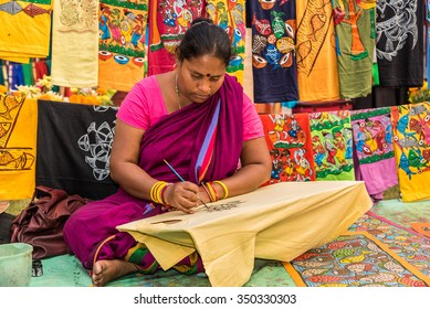 KOLKATA, INDIA - NOVEMBER 28: An Indian craftswoman paints on colorful handicraft items for sale during the annual State Handicrafts Expo 2015 on November 28, 2015 in Kolkata, West Bengal, India.