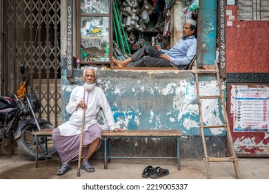 KOLKATA, INDIA - OCTOBER 01, 2022: Two Friends Are Sitting Outside A Local Shop