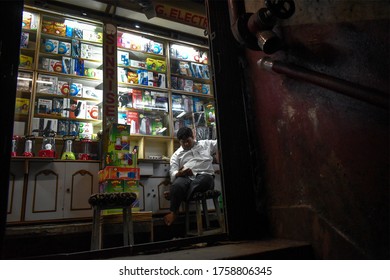 Kolkata, India,14/03/2020 - A Shopkeeper Is Busy With His Mobile On The Chandney Chowk Market In Kolkata, India.