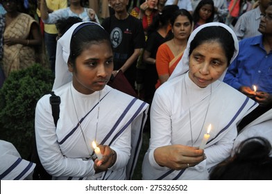 KOLKATA - MARCH 16 : Two Christian Nuns Standing Amongst Crowd Holding Candles During A Candle Light Vigil To Protest Gang Rape Of An Elderly Nun On March 16, 2015 At Allen Park In Kolkata, India.