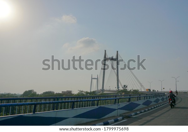 Kolkata, West Bengal, India - 25th July 2020 :
Sun rays in blue sky over 2nd Hoogly Bridge, The bridge connects
Howrah and Kolkata.
