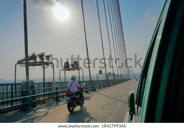Kolkata,\
West Bengal, India - 25th July 2020 : Sun rays in blue sky over 2nd\
Hoogly Bridge, connecting Howrah and\
Kolkata.